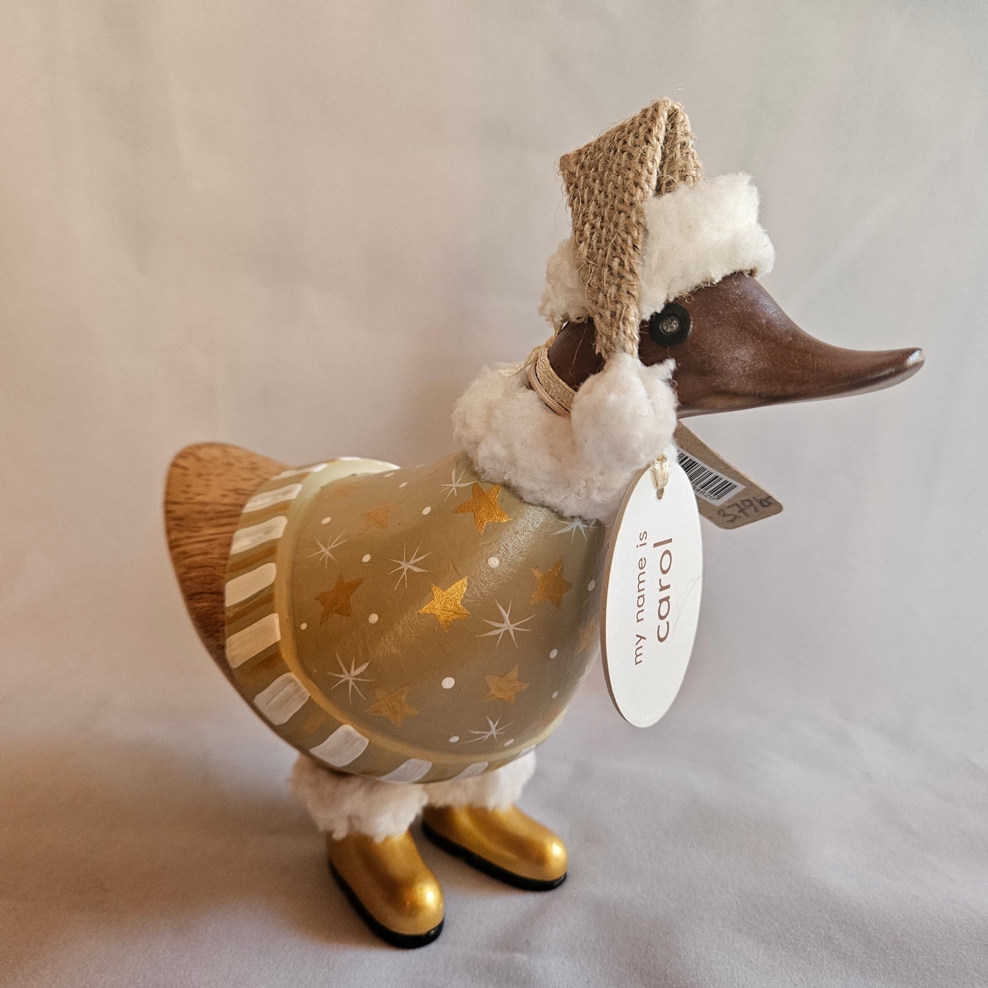 julanka i bambu med guldstövlar och beige dress med stjärnor - Naturboden